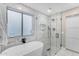 Bathroom with marble shower, soaking tub, and window at 25802 N Hackberry Dr, Phoenix, AZ 85083