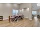 Modern dining room with a long wooden table and access to the kitchen at 25802 N Hackberry Dr, Phoenix, AZ 85083