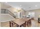 Bright dining room showcasing a long wooden table and modern light fixture at 25802 N Hackberry Dr, Phoenix, AZ 85083