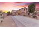 Two-story house with driveway, landscaping, and a sunset in the background at 25802 N Hackberry Dr, Phoenix, AZ 85083