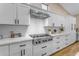 Modern kitchen with white cabinets, stainless steel appliances, and hexagonal backsplash at 25802 N Hackberry Dr, Phoenix, AZ 85083