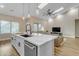 Modern kitchen with white cabinets, large island, and open-concept layout at 25802 N Hackberry Dr, Phoenix, AZ 85083