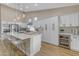 Modern kitchen with white cabinets, large island, and stainless steel appliances at 25802 N Hackberry Dr, Phoenix, AZ 85083