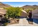 Single-story home with a two-car garage and desert landscaping at 26907 N 51St Dr, Phoenix, AZ 85083