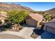 Single-story home with a two-car garage and desert landscaping at 26907 N 51St Dr, Phoenix, AZ 85083