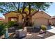 Tan house with a two-car garage and landscaping at 26907 N 51St Dr, Phoenix, AZ 85083