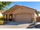 Tan house with a two-car garage and landscaping at 26907 N 51St Dr, Phoenix, AZ 85083