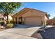 Tan house with a two-car garage and landscaping at 26907 N 51St Dr, Phoenix, AZ 85083