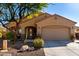 Tan house with a two-car garage and landscaping at 26907 N 51St Dr, Phoenix, AZ 85083