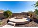 Circular fire pit area with stone seating at 26907 N 51St Dr, Phoenix, AZ 85083