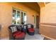 Cozy front porch with wicker chairs and side tables at 26907 N 51St Dr, Phoenix, AZ 85083