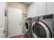 Laundry room with washer, dryer, and built-in cabinets at 26907 N 51St Dr, Phoenix, AZ 85083