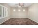 Living area with tile floors, window shutters, and ceiling fan at 26907 N 51St Dr, Phoenix, AZ 85083