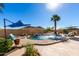 Inviting pool with waterfall feature, lounge chairs, and umbrellas at 26907 N 51St Dr, Phoenix, AZ 85083