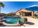 Inviting backyard pool with a blue umbrella and lounge chairs at 26907 N 51St Dr, Phoenix, AZ 85083