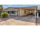 View of the front of the manufactured home, showcasing carport and landscaping at 2724 N Wright Way, Mesa, AZ 85215