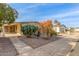 Landscaped manufactured home with a covered patio and mature desert plants at 2724 N Wright Way, Mesa, AZ 85215