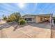 Well-maintained manufactured home with carport and mature desert landscaping at 2724 N Wright Way, Mesa, AZ 85215