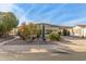 Desert landscaping surrounds this single-level manufactured home with carport at 2724 N Wright Way, Mesa, AZ 85215