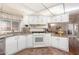 White kitchen with granite countertops and breakfast bar at 2724 N Wright Way, Mesa, AZ 85215