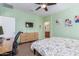 Spacious bedroom with a large bed, work area, and ceiling fan at 2981 E Nighthawk Way, Phoenix, AZ 85048