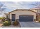 Tan house with gray garage door and landscaping at 2981 E Nighthawk Way, Phoenix, AZ 85048