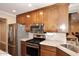 Modern kitchen with stainless steel appliances and wood cabinets at 3502 N 22 St, Phoenix, AZ 85016