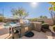 Built-in outdoor kitchen with grill and side burner at 3729 E Donald Dr, Phoenix, AZ 85050