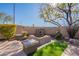 Landscaped backyard with fire pit and seating at 3729 E Donald Dr, Phoenix, AZ 85050