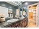 Double vanity bathroom with dark wood cabinets and a shower/tub combo at 3729 E Donald Dr, Phoenix, AZ 85050