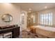 Elegant bathroom with soaking tub, walk-in shower, and granite vanity at 3729 E Donald Dr, Phoenix, AZ 85050