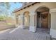 Elegant front entrance with arched entryway and brick walkway at 3729 E Donald Dr, Phoenix, AZ 85050