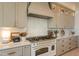 Gourmet kitchen features white appliances and custom cabinetry at 3729 E Donald Dr, Phoenix, AZ 85050