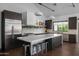 Spacious kitchen with marble countertops, dark wood cabinetry, and stainless steel appliances at 3837 E Heatherbrae Dr, Phoenix, AZ 85018