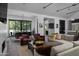 Spacious living room with light-colored sofas and a modern fireplace at 3837 E Heatherbrae Dr, Phoenix, AZ 85018