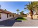 Backyard oasis with artificial turf, gravel, and a large palm tree at 3930 W Saragosa W St, Chandler, AZ 85226