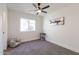 Bright bedroom with ceiling fan, carpeted floor, and charming decor at 3930 W Saragosa W St, Chandler, AZ 85226