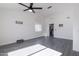 Spacious living room featuring gray vinyl flooring and a ceiling fan at 3930 W Saragosa W St, Chandler, AZ 85226