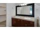 Bathroom boasts double sinks, dark wood cabinets, and a large mirror at 415 E Glenhaven Dr, Phoenix, AZ 85048