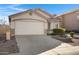 House exterior featuring a two-car garage and well-manicured landscaping at 415 E Glenhaven Dr, Phoenix, AZ 85048