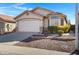 House exterior with a two-car garage and desert landscaping at 415 E Glenhaven Dr, Phoenix, AZ 85048