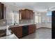 Kitchen with granite counters, dark wood cabinets and tile floor at 415 E Glenhaven Dr, Phoenix, AZ 85048