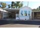 Front view of the home, showcasing carport and landscaping at 4220 E Main St # F-45, Mesa, AZ 85205