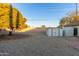 Spacious backyard with gravel, a shed, and a large tree providing shade at 4301 W Dahlia Dr, Glendale, AZ 85304