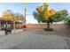 Large backyard with gravel landscaping, a tree, and a block wall at 4301 W Dahlia Dr, Glendale, AZ 85304