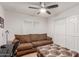 Cozy bedroom with a brown couch, a coffee table, and white closet doors at 4301 W Dahlia Dr, Glendale, AZ 85304