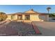 Single-story home with a rock garden, solar panels, and a two-car garage at 4301 W Dahlia Dr, Glendale, AZ 85304