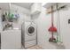 Laundry room with washer, dryer, and ample storage shelving at 4301 W Dahlia Dr, Glendale, AZ 85304