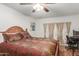 Main bedroom with a wooden bed frame and access to a patio at 4301 W Dahlia Dr, Glendale, AZ 85304