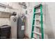 Utility closet with water heater, water softener, and ladder at 4301 W Dahlia Dr, Glendale, AZ 85304